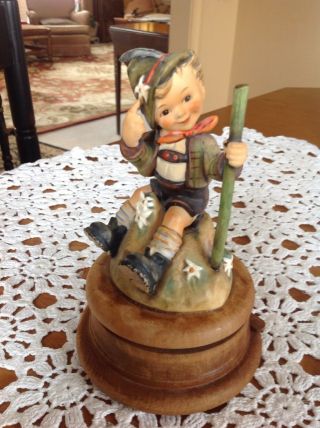 Hummel Figure Of Little Boy Sitting On A Rock With Musical Wooden Base