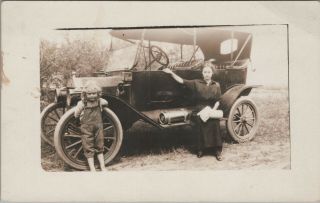 (m496) Vintage Postcard,  Rppc,  Woman And Child Sitting On A Automobile