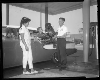 N316 1964 Negative.  Family,  Old Car,  Tidewater Oil Co.  Gas Station,  Attendant,  Toy