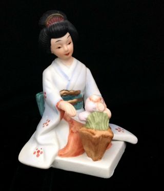 Bisque Porcelain Geisha With Flowers Figurine.