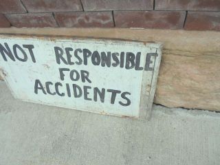 weathered wooden sign not responsible for accidents 27 