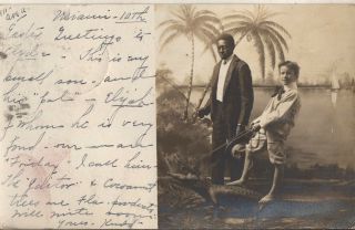 1905 Florida souvenir rppc young boy riding alligator with African American man 2