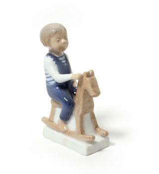 Porcelain figurine Boy with rocking horse.  Denmark,  Royal Copenhagen 5196. 2