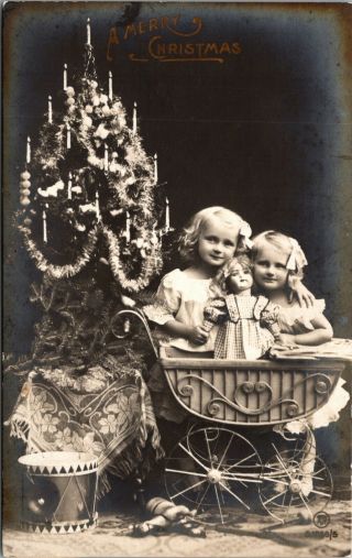 Photo Rppc Girl In Front Of Christmas Tree Toys Doll Postcard Vintage