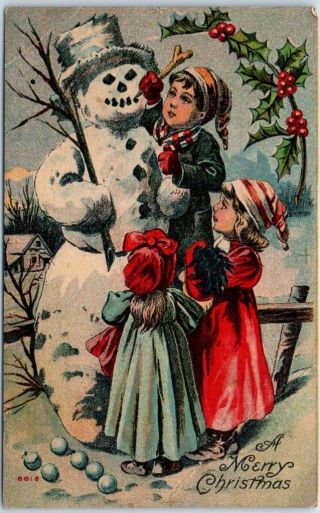 1910s Holiday Postcard " A Merry Christmas " Children Building Snowman Creased
