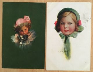 Two Postcards From 1921 Of A Girl With A Green Bow And A Girl With A Pink One.