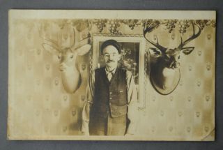 Ca 1910 Rppc Of Hunter With Glass Eye Flanked By Two Mounted Deer Heads