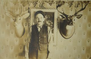 ca 1910 RPPC of Hunter with Glass Eye Flanked by Two Mounted Deer Heads 2