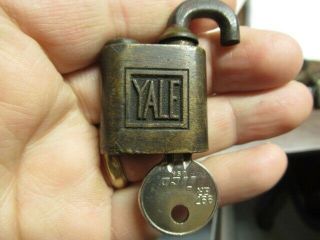 Old brass miniature YALE ptpk push padlock lock with a key and odd shackle.  n/r 5