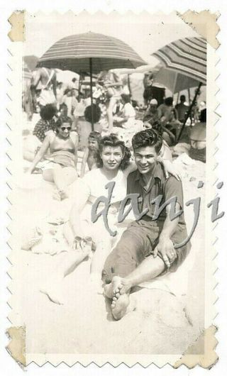 cute couple sitting on the beach with their FEET in the camera old Photo 2