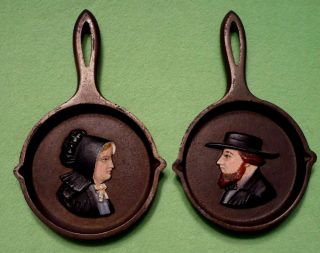 Set Of 2 Vintage Miniature Cast Iron Decorative Skillets With Amish Man & Woman.