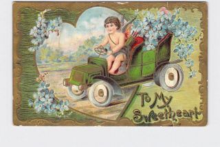 Antique Postcard Valentine Cupid Drives Antique Car Full Of Violets Embossed