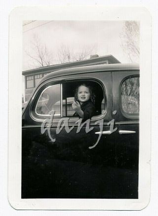 Young Girl With Gesturing Hand Looking Out Of The Driver 