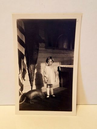 Weird And Creepy Girl Standing On A Porch With An Armadillo And Alligator Skin