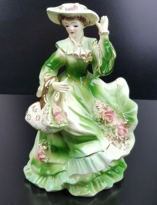 Vintage Porcelain Figurine Of A Woman In Victorian Clothing Made In Japan.