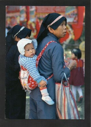 Hong Kong - A Village Woman Carries A Child While Visiting Local Market.  P/u 1993