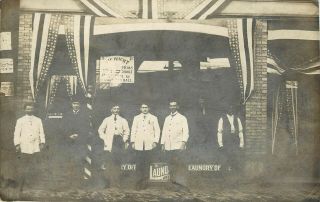 Rppc Men In White Coats At Laundry Office With Flag Bunting & Black Attendant