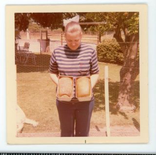 Woman Showing Off Two Loafs Of Freshly Baked Bread.  Vintage Color Snapshot Photo