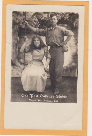 Real Photo Postcard Rppc Man & Woman On Swing Post - O - Graph Studio Hot Springs Ca