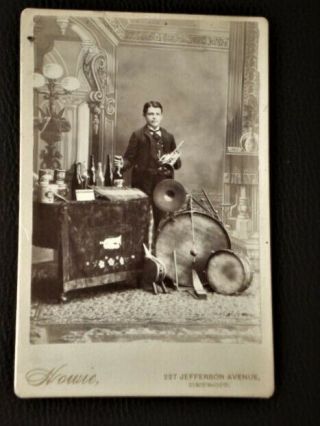 Cabinet Photo Of Young Man With Several Instruments