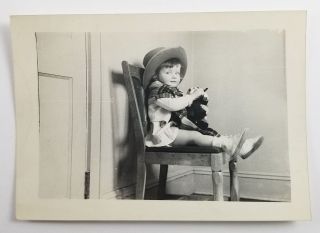 Vintage Photograph Of Girl Sitting On Chair Wearing Cowboy Hat Holding Toy