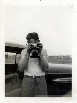 1955 Man In Tee Shirt Takes Photo W Camera Duelling Cameras