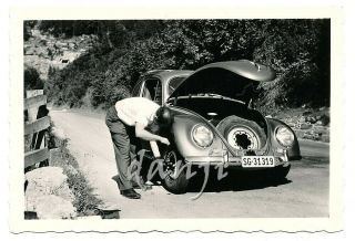 Bent Over Man Changing The Tire On A Vw Volkswagen Beetle Car Old Photo