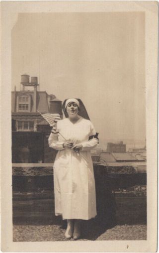 Nun Or Nurse Waving U.  S.  Flag On York Rooftop,  1920s