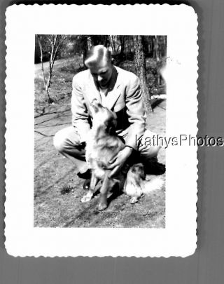 Black & White Photo M_9201 Man In Suit Squatting Behind Dog Sitting