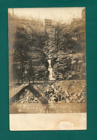 Piedmont Wv Real Photo Post Card View Of Swinging Bridge,  Waterfall,  Houses 1906