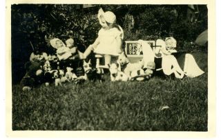 Adorable 1930s Photo Of Happy Baby Surrounded By Numerous Dolls & Toys