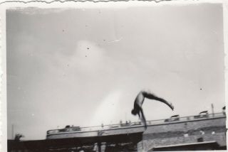 Vintage Photo Mid Air Dive Action Shot Next To Busy Bridge Abstract Blurry