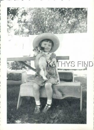 Found B&w Photo A,  0394 Girl In Dress And Hat Sitting Holding Dog