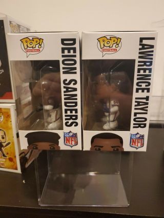 FUNKO POP DEION SANDERS 93 LAWRENCE TAYLOR 79.  TOYS R US EXCLUSIVE.  CHECK PICS 3
