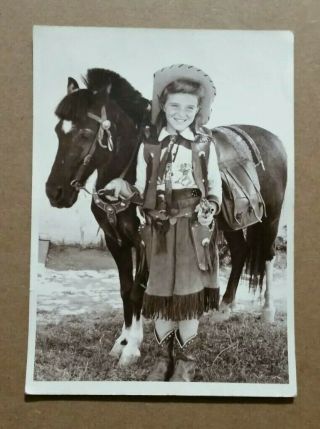 Young Girl In Cowgirl Outfit Holding Reins Of Her Pony,  Vintage Photo,  1940 