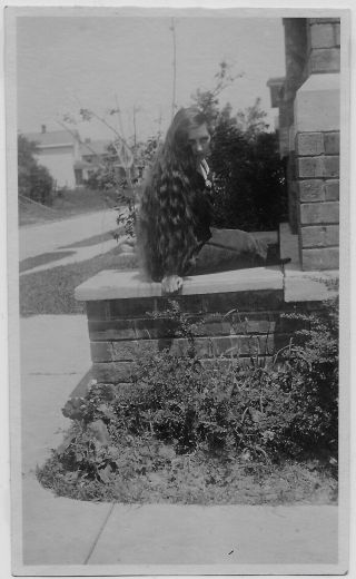 Old Photo Woman With Long Wavy Hair Sitting On Wall 1920s