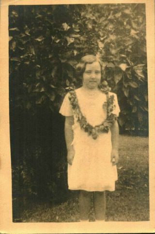Vintage Photo Card White Dress Young Girl Wears Handmade Lei Tree Bush Outdoor