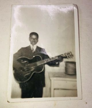Antique Black And White Photo Of Musician Posing With His Guitar