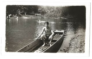 Young Man In Swim Trunks Sits In Canoe On Lake Or Water Snapshot Vintage Photo