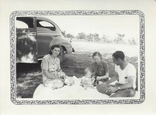 Two Women,  Man And Baby Sitting On Blanket By Old Car Vintage Photograph