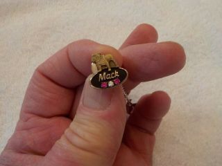 10 KT.  GOLD MACK TRUCK AWARD PIN WITH 2 RUBY CHIPS AND ONE DIAMOND CHIP 2