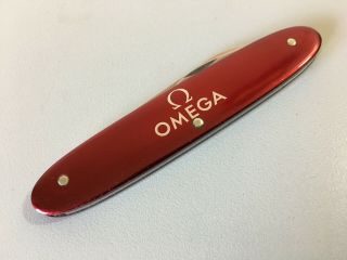 Omega Victorinox Swiss army knife/watch case opener - vintage,  deep red color 2