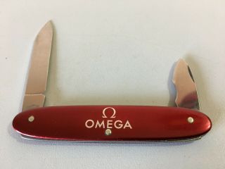 Omega Victorinox Swiss army knife/watch case opener - vintage,  deep red color 5