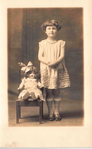 Photo Studio Real Photo Postcard Young Girl With Doll Sitting In Chair 114661