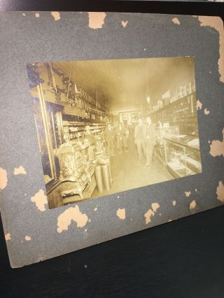 Antique Photo Of Men In Old Hardware Store.  Wood Stoves,  Holding Gun And Posing.