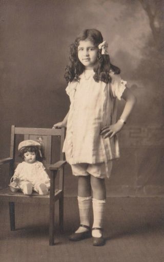 Rppc.  Studio Portrait Of Girl With Doll On Chair