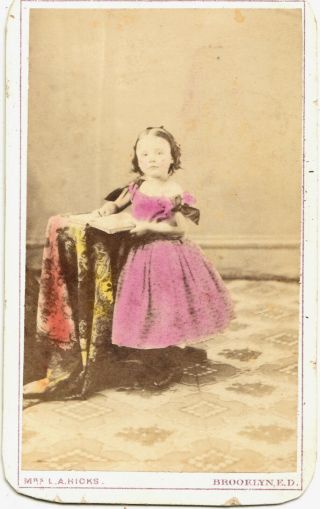 Cdv: Little Girl Standing With Book; Tinted - By Mrs.  L A Hicks,  Brooklyn,  E D