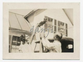 Couple By Antique Car Look Up At Cat Sitting On A Thin Post Old Photo