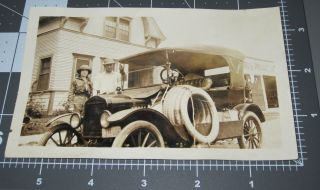 Man Scout Woman W/ Multiple Spare Tires Tied To Car Sign In Back Vintage Photo