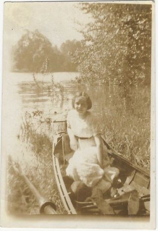 1910s Young Woman In Canoe On River Bank Snapshot